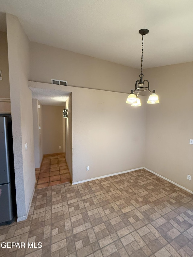 12304 Bill Mitchell Dr, El Paso, TX 79938 - empty room with brick patterned floors and a chandelier