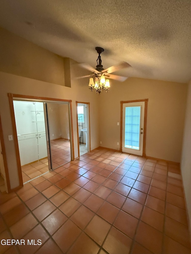 12304 Bill Mitchell Dr, El Paso, TX 79938 - empty room featuring lofted ceiling, ceiling fan, light tile patterned floors, and a textured ceiling
