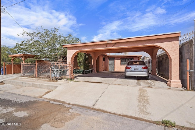 204 Ruth St, Anthony, NM 88021 - view of parking featuring driveway, a carport, and a gate