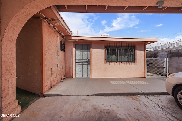 204 Ruth St, Anthony, NM 88021 - view of exterior entry featuring stucco siding and a gate
