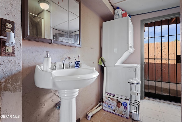 204 Ruth St, Anthony, NM 88021 - full bathroom with stacked washer / dryer and tile patterned flooring