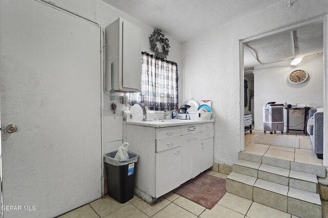 204 Ruth St, Anthony, NM 88021 - bathroom with tile patterned flooring, vanity, and a textured ceiling