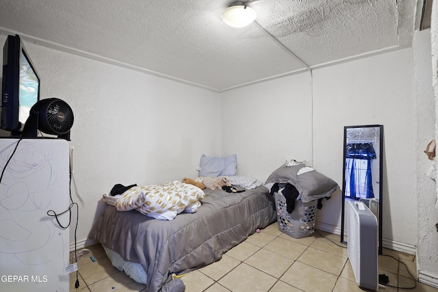 204 Ruth St, Anthony, NM 88021 - tiled bedroom with a textured ceiling and a textured wall