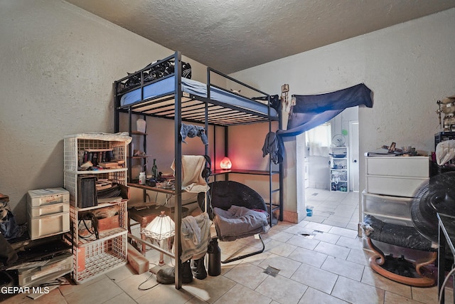 204 Ruth St, Anthony, NM 88021 - tiled bedroom featuring a textured ceiling and a textured wall