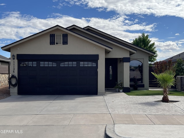 11128 Colbert Coldwell Ln, Socorro, TX 79927 - single story home with stucco siding, a garage, and concrete driveway