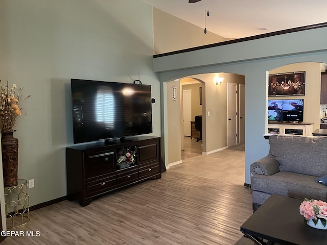 11128 Colbert Coldwell Ln, Socorro, TX 79927 - living area featuring arched walkways, a ceiling fan, and wood finished floors