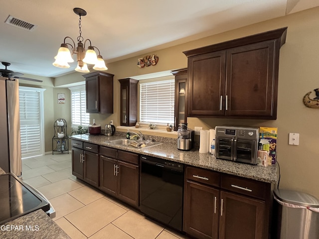 11128 Colbert Coldwell Ln, Socorro, TX 79927 - kitchen with black appliances, light tile patterned floors, dark brown cabinetry, and hanging light fixtures