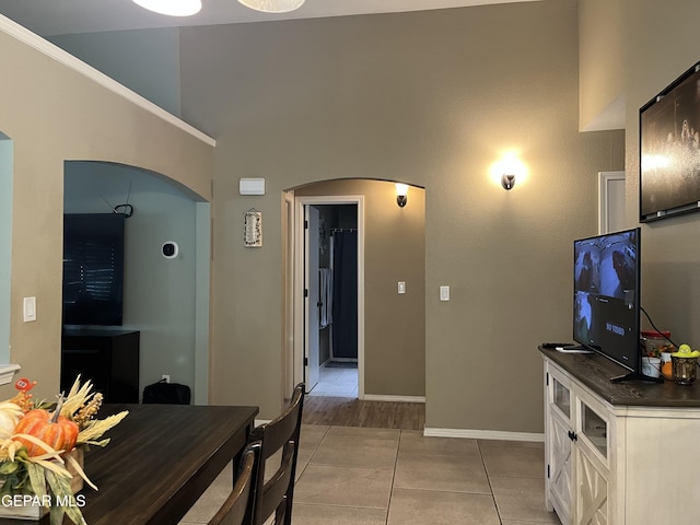 11128 Colbert Coldwell Ln, Socorro, TX 79927 - living area with arched walkways, light tile patterned floors, and a high ceiling