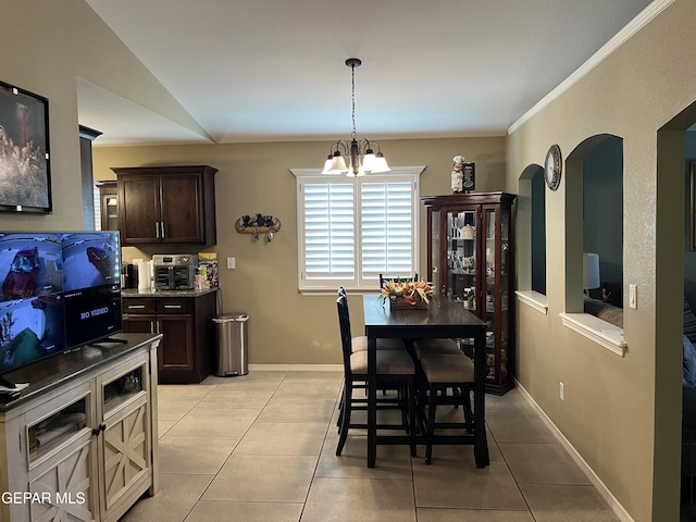 11128 Colbert Coldwell Ln, Socorro, TX 79927 - dining space featuring light tile patterned floors, arched walkways, and a chandelier