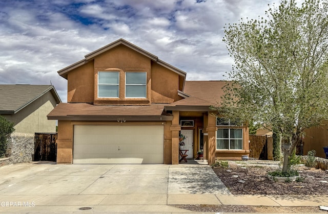 14177 Spanish Point Dr, El Paso, TX 79938 - view of front of house featuring an attached garage, concrete driveway, and stucco siding