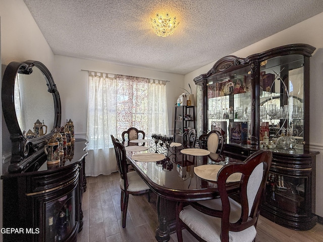 14177 Spanish Point Dr, El Paso, TX 79938 - dining area with a textured ceiling and wood finished floors