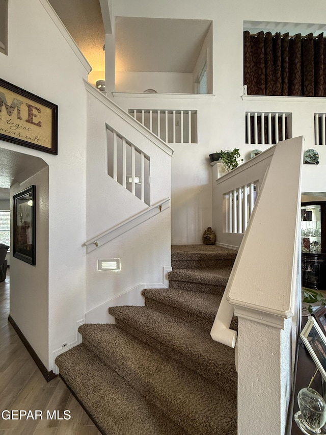 14177 Spanish Point Dr, El Paso, TX 79938 - stairs with wood finished floors and baseboards
