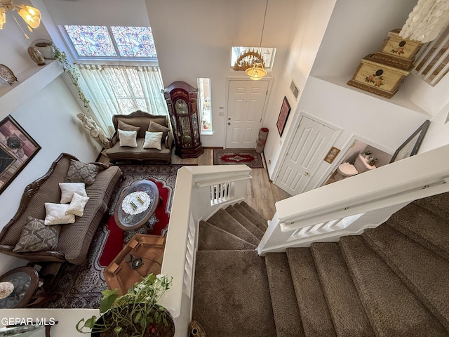14177 Spanish Point Dr, El Paso, TX 79938 - foyer entrance featuring a towering ceiling, stairs, wood finished floors, and a chandelier
