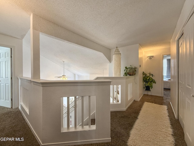 14177 Spanish Point Dr, El Paso, TX 79938 - hallway with a textured ceiling, carpet floors, and an upstairs landing