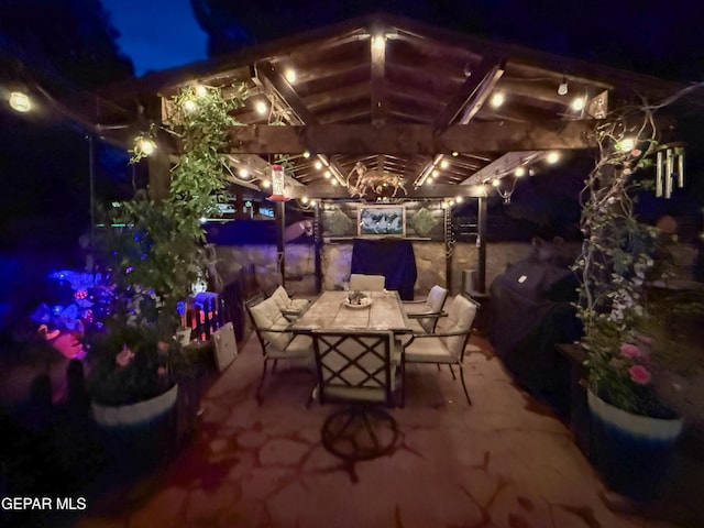 14177 Spanish Point Dr, El Paso, TX 79938 - patio at night featuring outdoor dining area, a patio, and a grill
