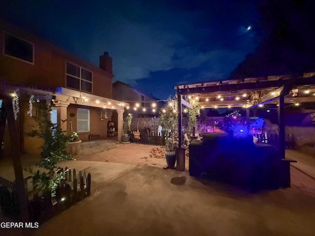 14177 Spanish Point Dr, El Paso, TX 79938 - patio at night featuring a patio area and a pergola