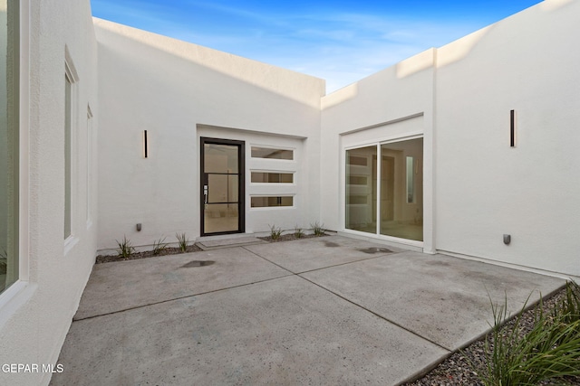 7349 Cimarron Rim Dr, El Paso, TX 79911 - rear view of property with stucco siding and a patio