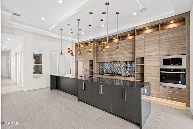 7349 Cimarron Rim Dr, El Paso, TX 79911 - kitchen with stainless steel appliances, modern cabinets, a large island with sink, recessed lighting, and a tray ceiling