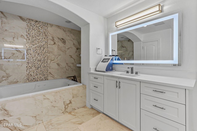 6528 Calle Placido Dr, El Paso, TX 79912 - full bathroom with marble look tiles, vanity, and a tub with marble appearance