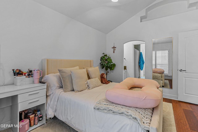 6528 Calle Placido Dr, El Paso, TX 79912 - bedroom featuring lofted ceiling, wood finished floors, and arched walkways