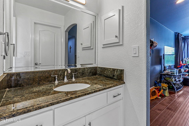 6528 Calle Placido Dr, El Paso, TX 79912 - bathroom featuring vanity, wood finished floors, and a textured wall