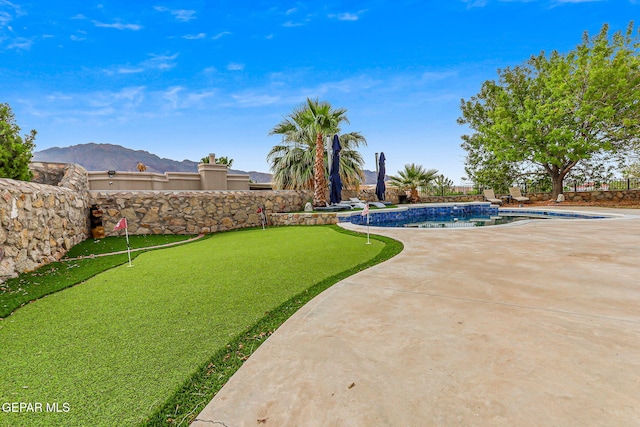 6528 Calle Placido Dr, El Paso, TX 79912 - view of yard with a putting area, a patio area, and a mountain view