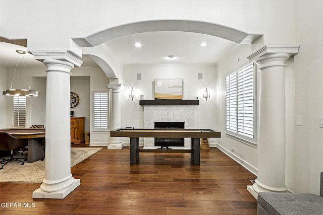 6528 Calle Placido Dr, El Paso, TX 79912 - game room with decorative columns, a fireplace, hardwood / wood-style flooring, arched walkways, and recessed lighting