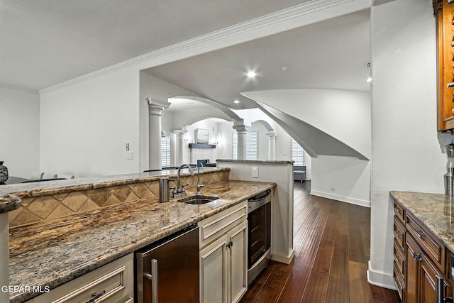 6528 Calle Placido Dr, El Paso, TX 79912 - kitchen with decorative columns, beverage cooler, stone counters, arched walkways, and recessed lighting