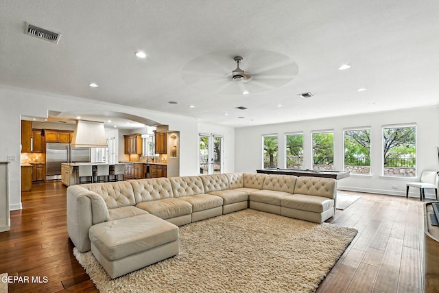 6528 Calle Placido Dr, El Paso, TX 79912 - living room featuring ceiling fan, dark wood-style flooring, arched walkways, recessed lighting, and crown molding