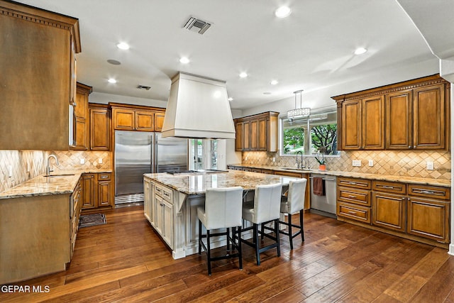 6528 Calle Placido Dr, El Paso, TX 79912 - kitchen with appliances with stainless steel finishes, custom exhaust hood, a center island, backsplash, and recessed lighting
