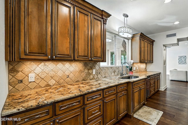6528 Calle Placido Dr, El Paso, TX 79912 - kitchen featuring light stone countertops, dark wood-style floors, backsplash, decorative light fixtures, and recessed lighting