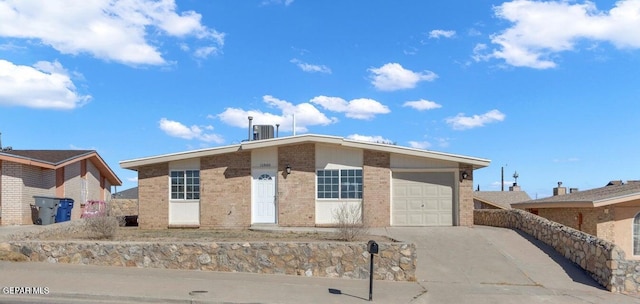 11860 Jim Ferriell Dr, El Paso, TX 79936 - ranch-style home with concrete driveway, a garage, and brick siding