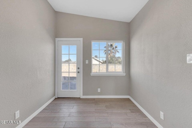 11860 Jim Ferriell Dr, El Paso, TX 79936 - empty room featuring wood finished floors, a textured wall, and lofted ceiling