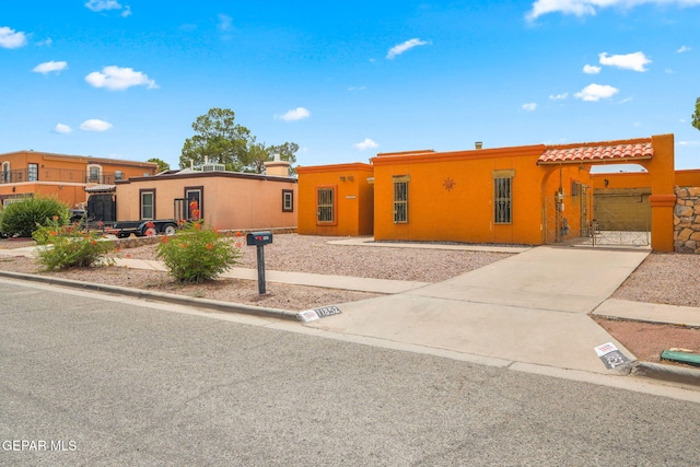11852 Pete Rose Dr, El Paso, TX 79936 - view of front of home with stucco siding, driveway, and a tile roof