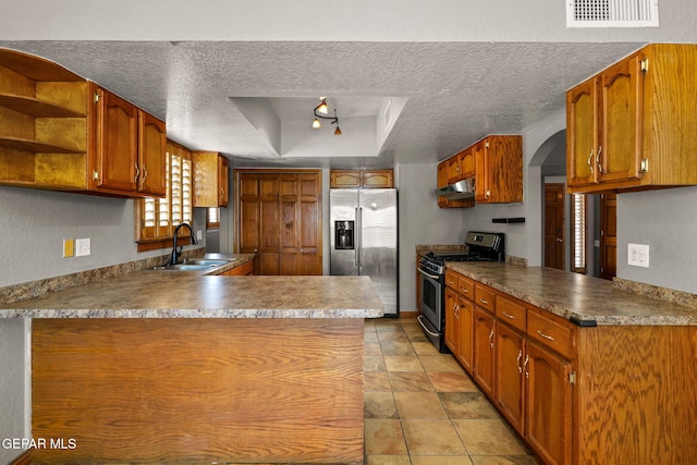 11852 Pete Rose Dr, El Paso, TX 79936 - kitchen with appliances with stainless steel finishes, under cabinet range hood, a raised ceiling, a peninsula, and a textured ceiling
