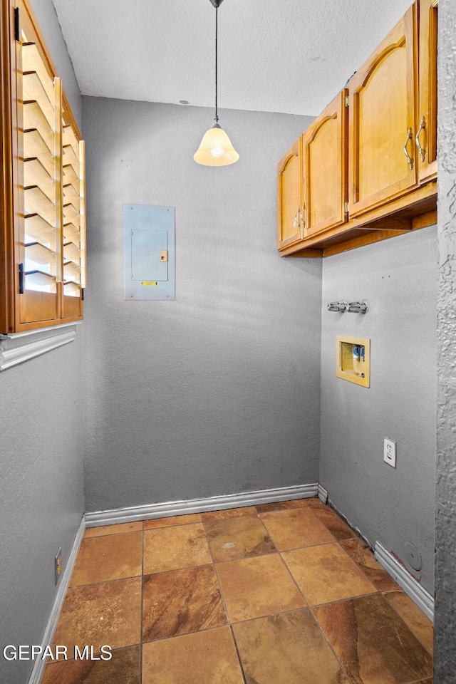 11852 Pete Rose Dr, El Paso, TX 79936 - laundry area featuring washer hookup, electric panel, cabinet space, and stone finish flooring