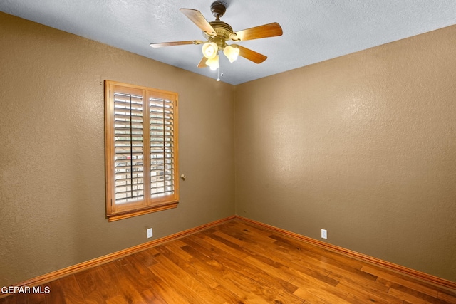 11852 Pete Rose Dr, El Paso, TX 79936 - spare room featuring wood finished floors, a ceiling fan, a textured wall, and a textured ceiling