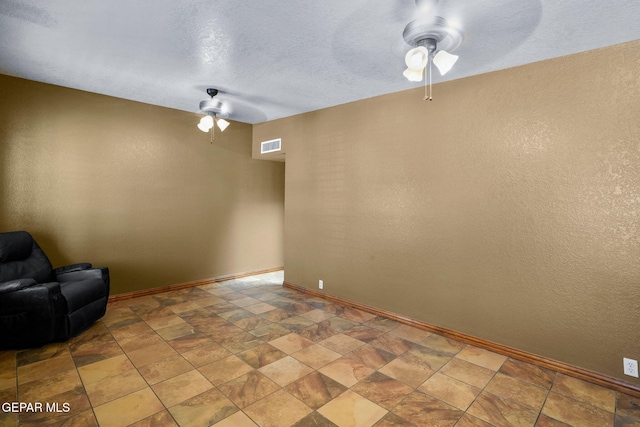 11852 Pete Rose Dr, El Paso, TX 79936 - unfurnished room featuring ceiling fan, stone finish floors, and a textured wall