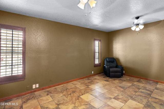 11852 Pete Rose Dr, El Paso, TX 79936 - unfurnished room featuring a ceiling fan, healthy amount of natural light, a textured ceiling, and a textured wall