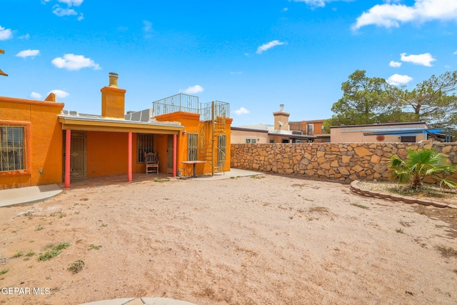 11852 Pete Rose Dr, El Paso, TX 79936 - back of house featuring a chimney