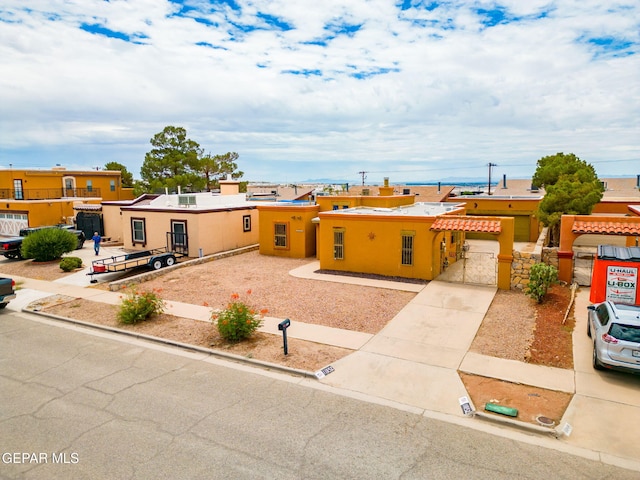 11852 Pete Rose Dr, El Paso, TX 79936 - view of front of property with a gate, concrete driveway, and stucco siding