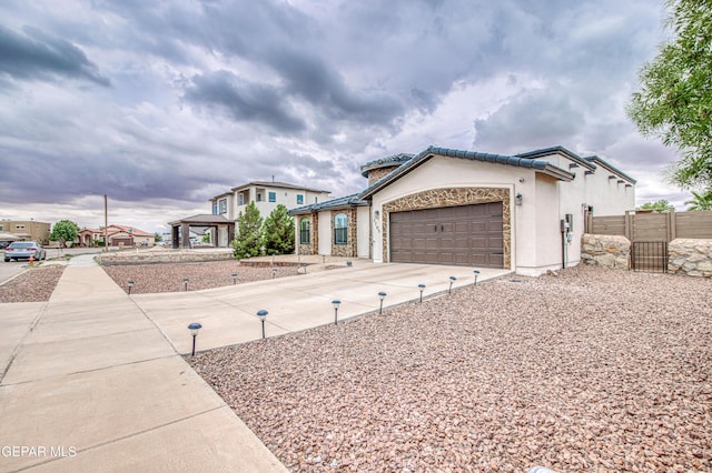 5705 Valley Lilac Ln, El Paso, TX 79932 - view of front of property with an attached garage, driveway, a tiled roof, a gazebo, and stucco siding