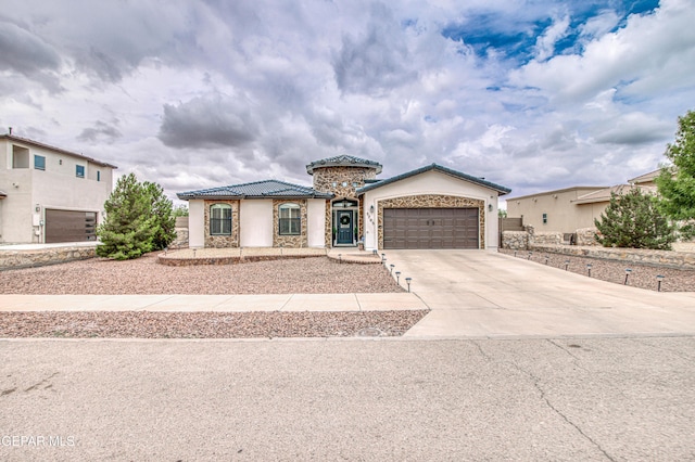 5705 Valley Lilac Ln, El Paso, TX 79932 - mediterranean / spanish-style house featuring concrete driveway, a garage, a tile roof, and stucco siding