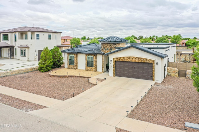 5705 Valley Lilac Ln, El Paso, TX 79932 - view of front of house with stone siding, driveway, stucco siding, a garage, and a tile roof
