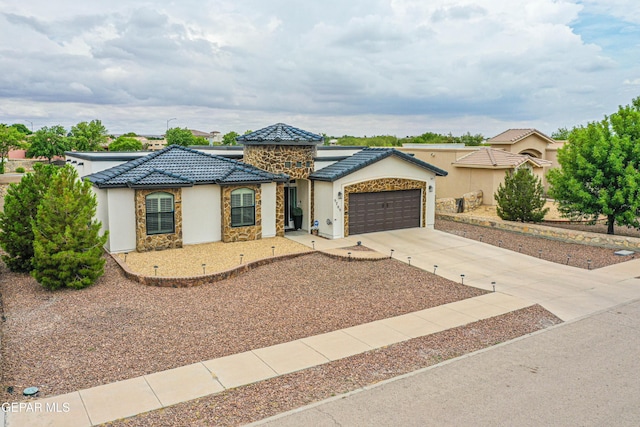 5705 Valley Lilac Ln, El Paso, TX 79932 - mediterranean / spanish-style house featuring stone siding, stucco siding, a tiled roof, and concrete driveway