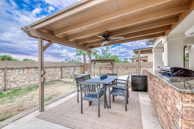 5705 Valley Lilac Ln, El Paso, TX 79932 - fenced backyard featuring a patio, a ceiling fan, outdoor dining space, and an outdoor kitchen