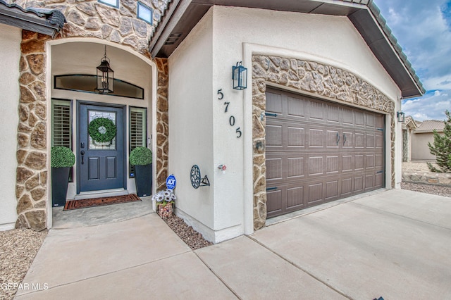 5705 Valley Lilac Ln, El Paso, TX 79932 - property entrance featuring stone siding, stucco siding, driveway, and an attached garage