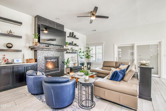 5705 Valley Lilac Ln, El Paso, TX 79932 - living area featuring a ceiling fan, a tile fireplace, and light wood-style flooring