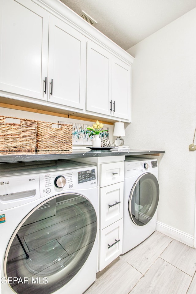 5705 Valley Lilac Ln, El Paso, TX 79932 - laundry room with washing machine and clothes dryer and cabinet space
