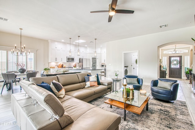 5705 Valley Lilac Ln, El Paso, TX 79932 - living area with a chandelier, a ceiling fan, arched walkways, light wood-type flooring, and recessed lighting
